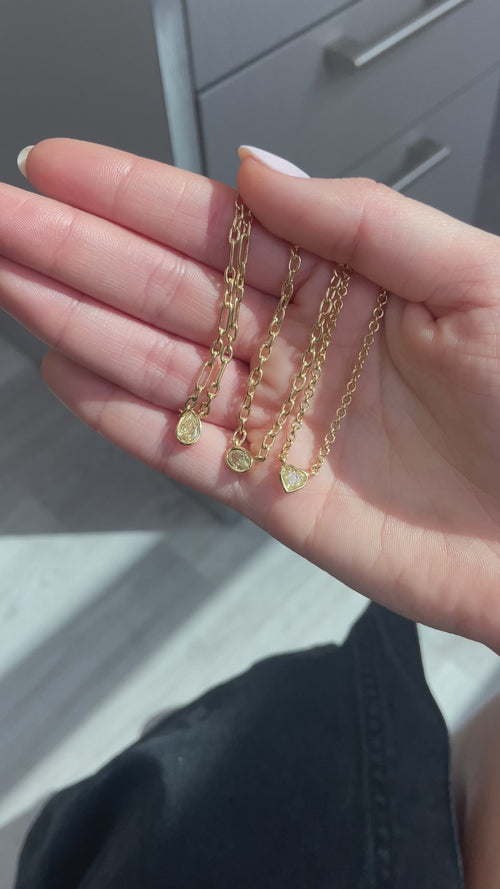 Canary diamond necklace, yellow oval cut diamond on a golden chain, bezel set yellow diamond