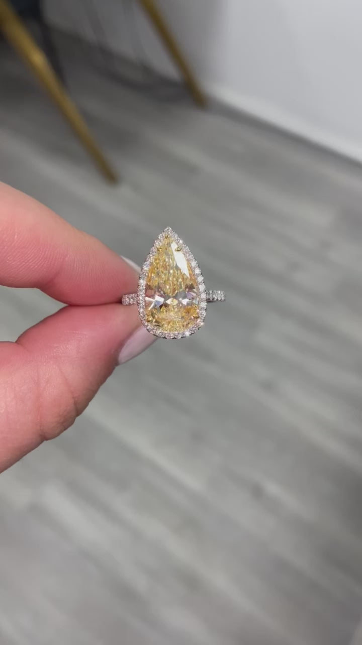 yellow pear shape diamond ring. yellow diamond pear shape. yellow pear shape halo ring. yellow diamond pear. yellow diamond ring.