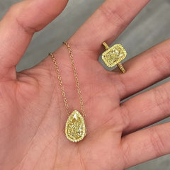 Elegant GIA certified pear shaped canary diamond necklace in yellow gold with yellow diamonds.