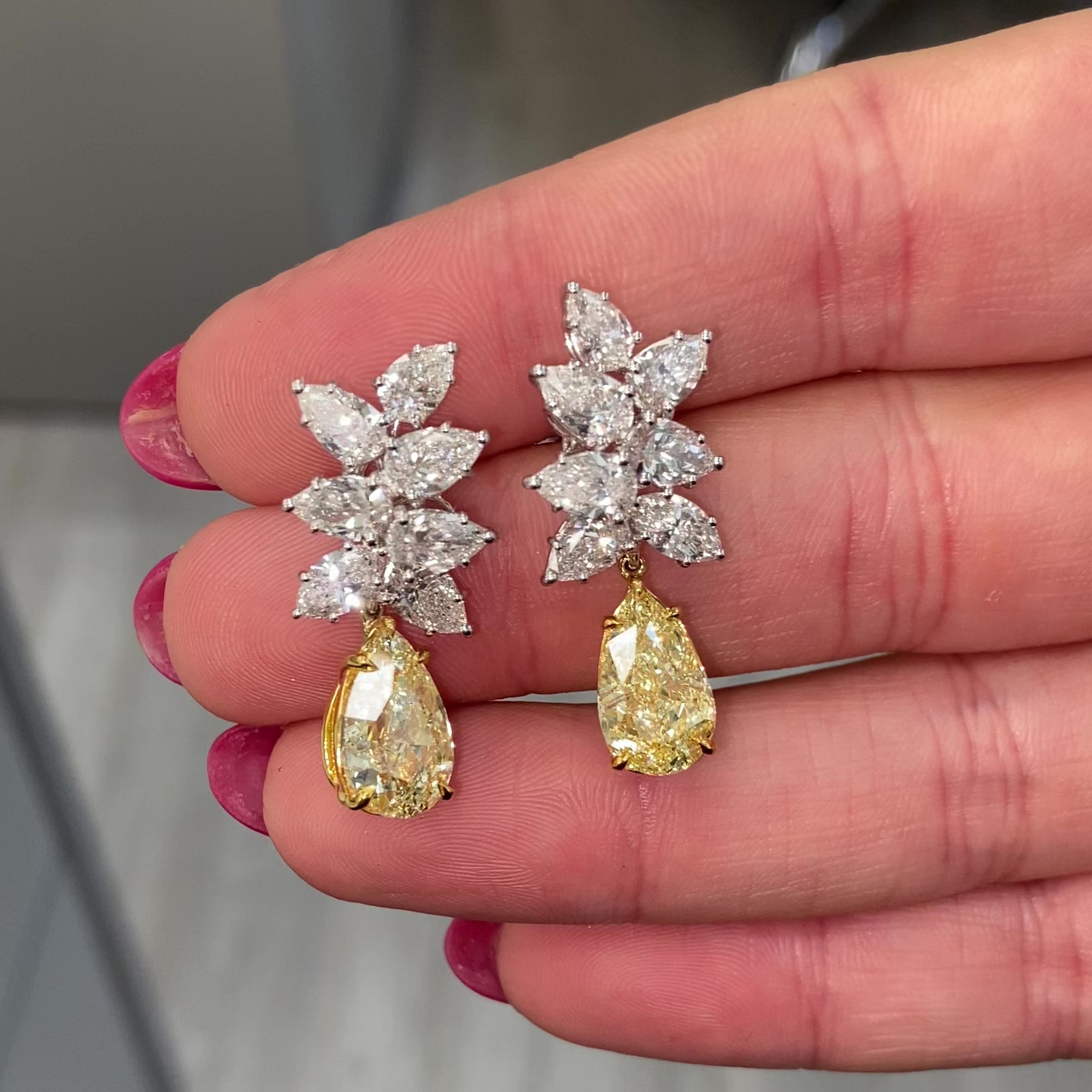 Fancy Light Yellow pear shape diamond earrings Natural yellow pear shape diamond cluster drop earrings with a total of 13.29 carats of natural white and yellow diamonds. Featuring 3 carat each, GIA Certified Fancy Light Yellow pear shape center diamonds with VS1 and VVS2 clarity.