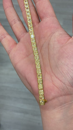 Fancy Yellow radiant cut diamond tennis bracelet with bezel-set diamonds in a sleek design with a SI and VS clarity.