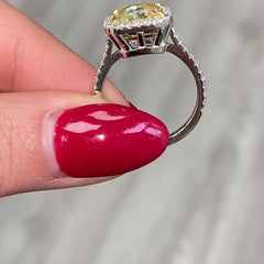 GIA certified natural canary yellow diamond ring surrounded by a halo of white diamonds.