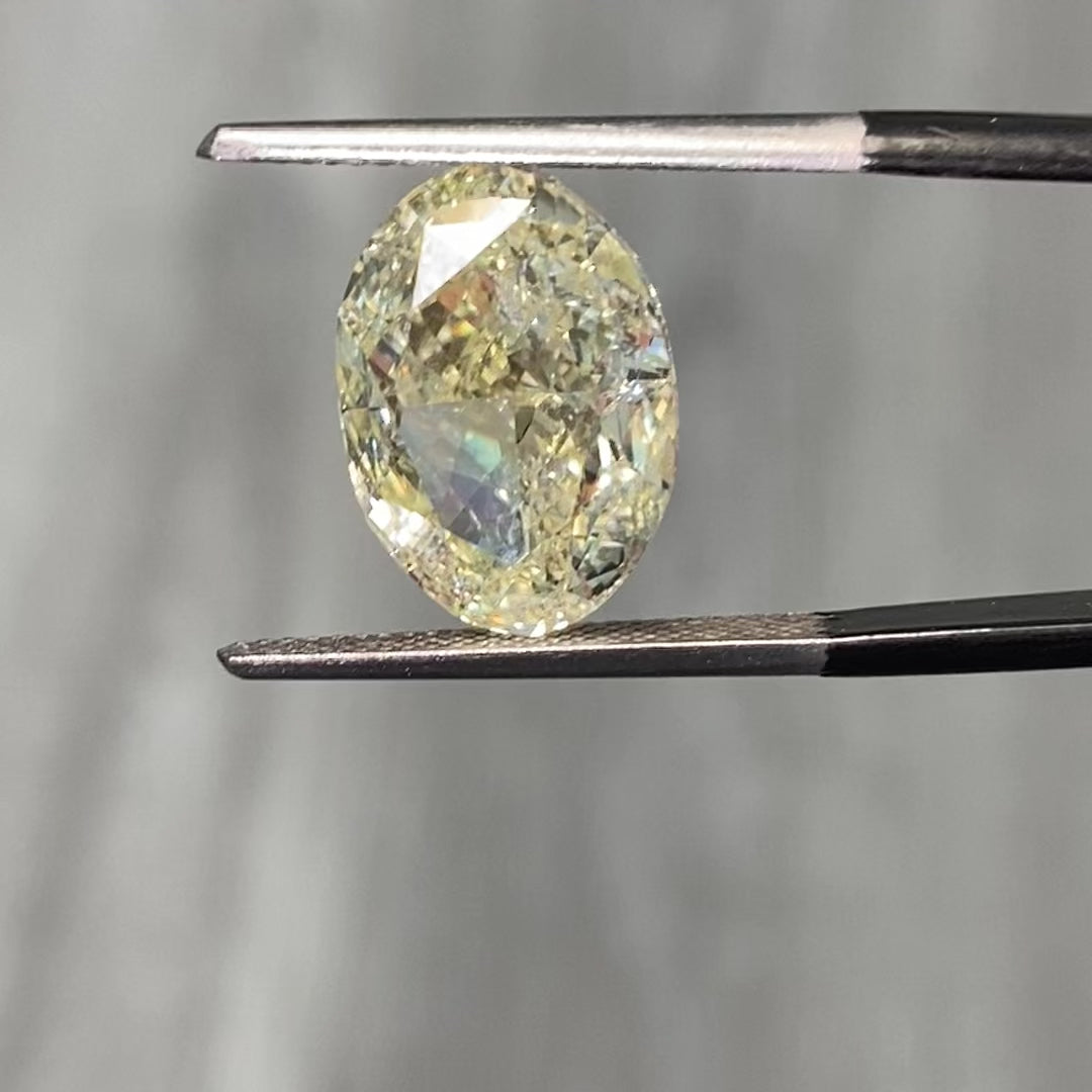 Light yellow oval cut diamond with VS1 clarity, excellent cut, GIA certified.