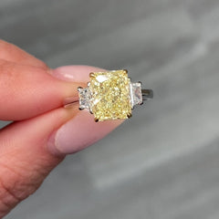 Fancy light yellow elongated radiant cut diamond engagement ring with VVS2 clarity.