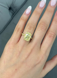 GIA certified light yellow elongated cushion cut diamond ring with canary yellow and golden yellow diamonds, SI1 clarity.