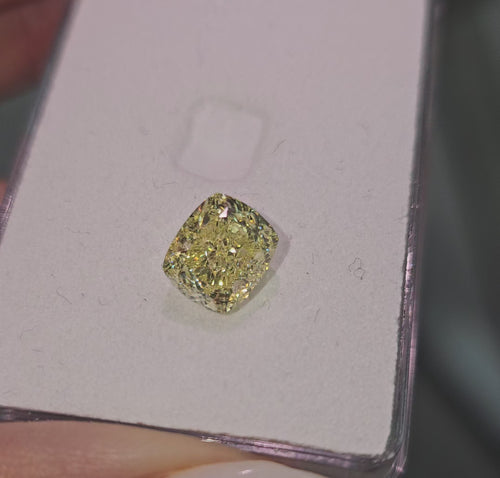 GIA certified fancy yellow cushion cut natural diamond with VS2 clarity and excellent cut.