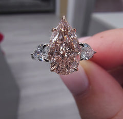 2.79 Total Carat Weight 2.18 Carat Center Pear Shape Diamond GIA Certified Fancy Light Brownish Pink VS1 clarity 0.61 W Pear Shape Side Diamonds Excellent, Very Good, No Fluorescence Handcrafted in NYC