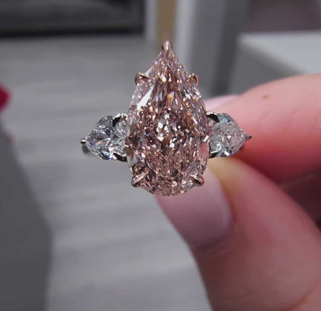 2.79 Total Carat Weight 2.18 Carat Center Pear Shape Diamond GIA Certified Fancy Light Brownish Pink VS1 clarity 0.61 W Pear Shape Side Diamonds Excellent, Very Good, No Fluorescence Handcrafted in NYC