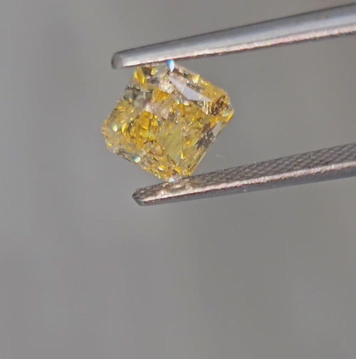 Vivid orange yellow radiant diamond with GIA certification and exceptional VVS1 clarity.