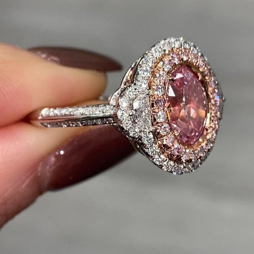 Ethereal natural pink oval diamond ring with a stunning halo design with SI1 clarity.