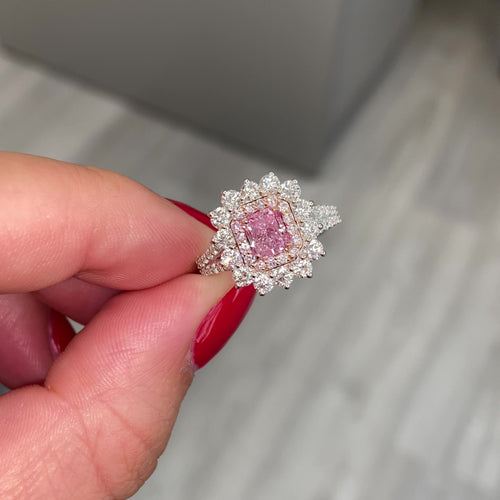 Fancy purplish pink radiant cut diamond ring with diamond halo. 