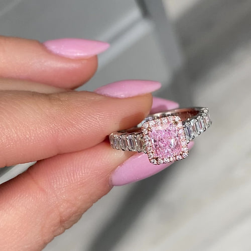 bubblegum pink diamond, pink radiant cut diamond surrounded by emerald cut and round diamonds, halo engagement ring with natural pink diamond