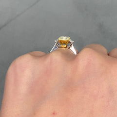 2.28 Carat Center Fancy Light Yellow Cushion Cut Diamond  SI2 Clarity 0.32 Carats of E Color Trapezoids GIA Certified Diamond  Crafted in Platinum and 18k Yellow Gold Handmade in NYC