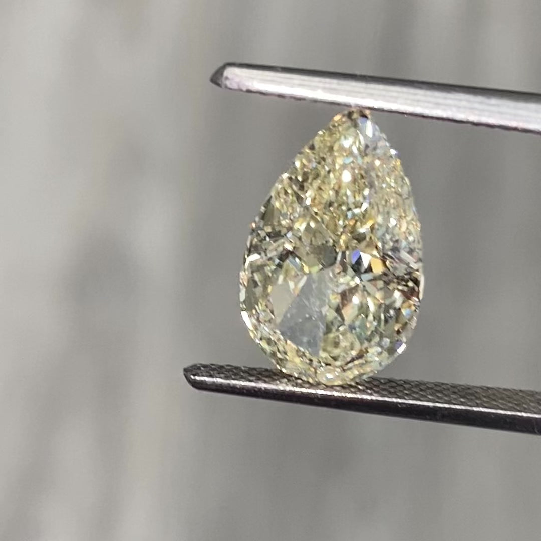 Light yellow pear-shaped diamond with VS1 clarity, excellent cut, and GIA certified.