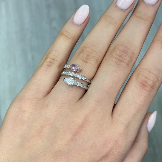 pink diamond statement ring, pink and white pear shape diamonds with emerald cut diamonds along the band