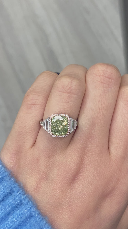 4 Carat GIA certified Green Diamond Ring with white step cut diamond side stones.