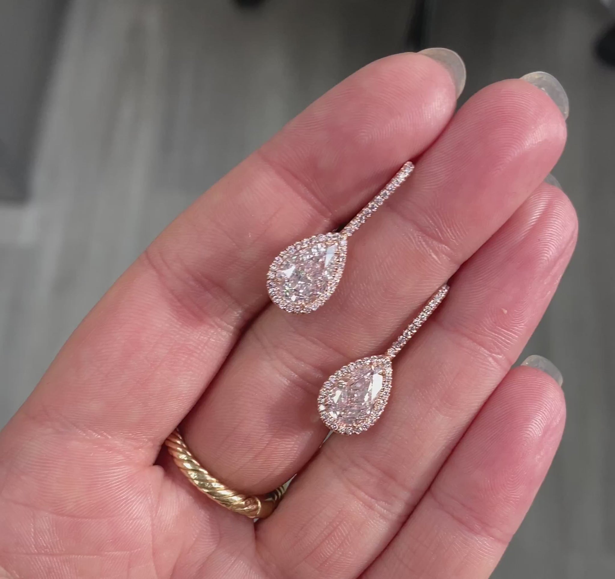 Handmade rose gold earrings featuring a rare matched pair of 2 carat each light pink pear shape diamonds and round pink diamonds
