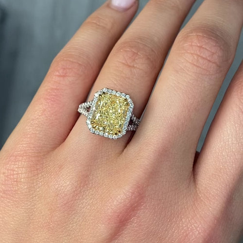 Light yellow radiant cut diamond engagement ring with a white diamond halo, VS2 clarity.