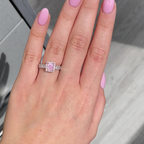 bubblegum pink diamond, pink radiant cut diamond surrounded by emerald cut and round diamonds, halo engagement ring with natural pink diamond