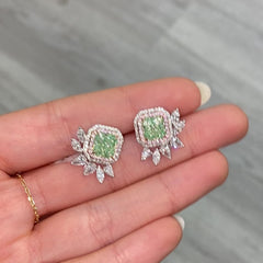 Unique green diamond stud earrings surrounded by natural pink and white diamond halos.