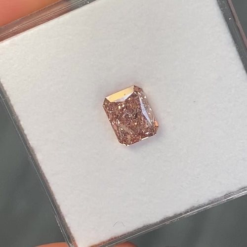 GIA certified fancy brown-pink elongated radiant diamond with VS1 clarity and no fluorescence.