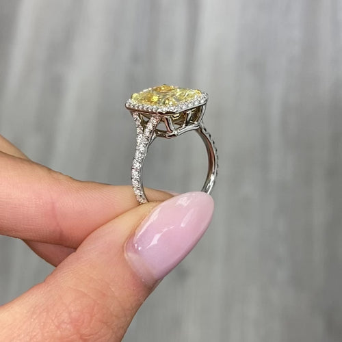 Elongated yellow diamond ring with white diamonds 