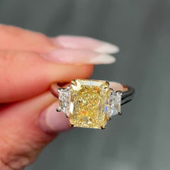 Fancy light yellow elongated radiant cut diamond engagement ring with VVS1 clarity.