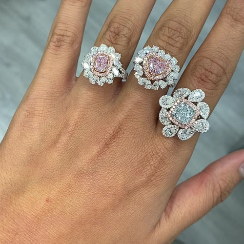 Pink heart shape diamond with white and pink surrounding diamonds.