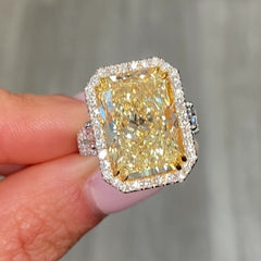 GIA certified elongated radiant yellow diamond halo ring, featuring a soft and sweet yellow hue.