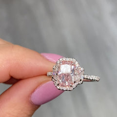 1.5 carat elongated radiant cut diamond ring. natural pink diamond ring, fancy light orangy pink diamond, halo diamond ring with pink diamond