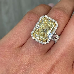 GIA certified elongated radiant yellow diamond halo ring, featuring a soft and sweet yellow hue.