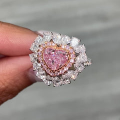 Pink heart shape diamond with white and pink surrounding diamonds.