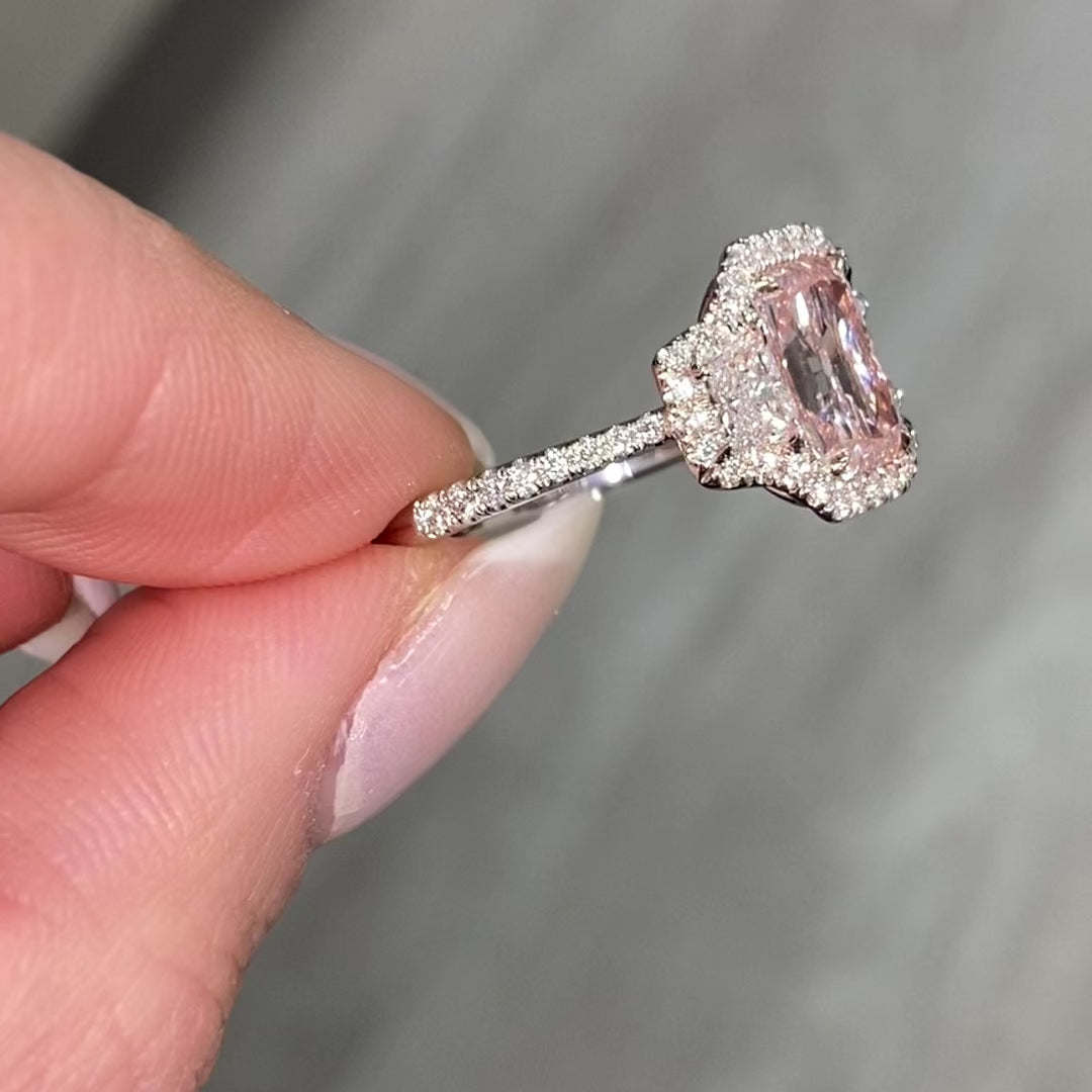 1.5 carat elongated radiant cut diamond ring. natural pink diamond ring, fancy light orangy pink diamond, halo diamond ring with pink diamond.