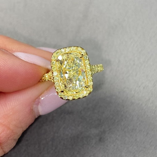 GIA certified light yellow elongated cushion cut diamond ring with canary yellow and golden yellow diamonds, SI1 clarity.