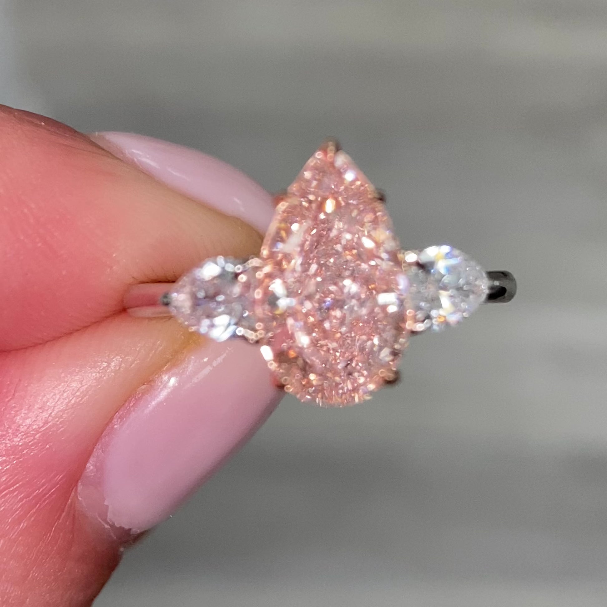 2.79 Total Carat Weight 2.18 Carat Center Pear Shape Diamond GIA Certified Fancy Light Brownish Pink VS1 clarity 0.61 W Pear Shape Side Diamonds Excellent, Very Good, No Fluorescence Handcrafted in NYC