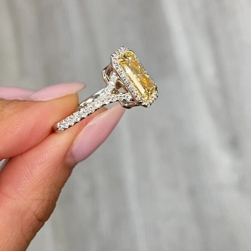 Yellow diamond ring with white surrounding diamonds