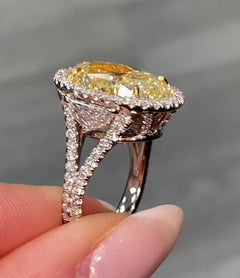 Yellow Oval Diamond Halo Ring with a handcrafted setting and GIA certified side diamonds.