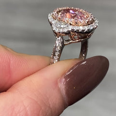 Ethereal natural pink oval diamond ring with a stunning halo design with SI1 clarity.