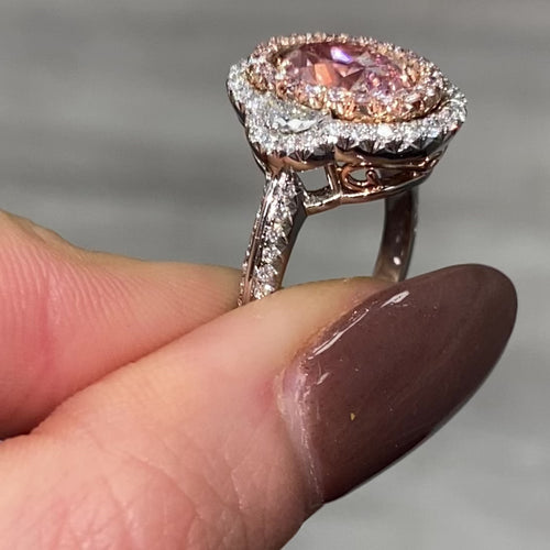 Ethereal natural pink oval diamond ring with a stunning halo design with SI1 clarity.