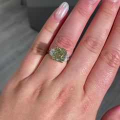 Fancy Yellow-Green cushion cut diamond engagement ring with VS2 clarity and a unique hue.