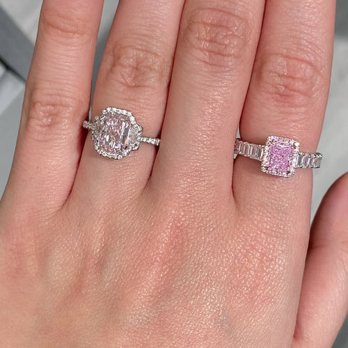 bubblegum pink diamond, pink radiant cut diamond surrounded by emerald cut and round diamonds, halo engagement ring with natural pink diamond