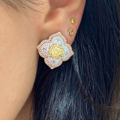 Light yellow and fancy light yellow diamond studs, in a flower theme with 1.5 carats of surrounding white and yellow diamonds