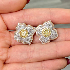 Light yellow and fancy light yellow diamond studs, in a flower theme with 1.5 carats of surrounding white and yellow diamonds