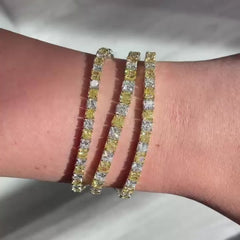 Alternating yellow and white diamond bracelet. tennis bracelet. alternating diamond bracelet. yellow diamond cushions.