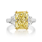 Fancy light yellow elongated radiant cut diamond ring.