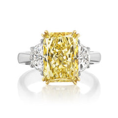 Fancy light yellow elongated radiant cut diamond ring.
