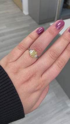 GIA yellow diamond, three stone ring. yellow diamond cushion. fancy light yellow. yellow diamond jewelry.