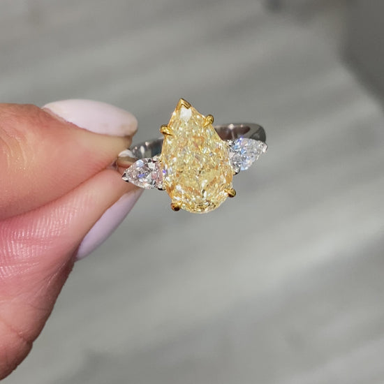 yellow diamond ring. yellow diamond pear shape. yellow diamonds. fancy yellow pear shape.