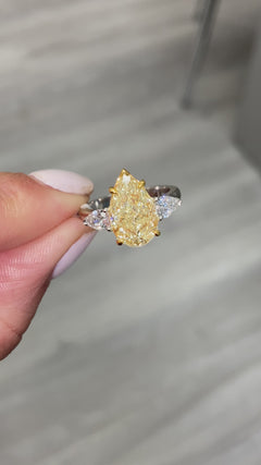 yellow diamond ring. yellow diamond pear shape. yellow diamonds. fancy yellow pear shape.