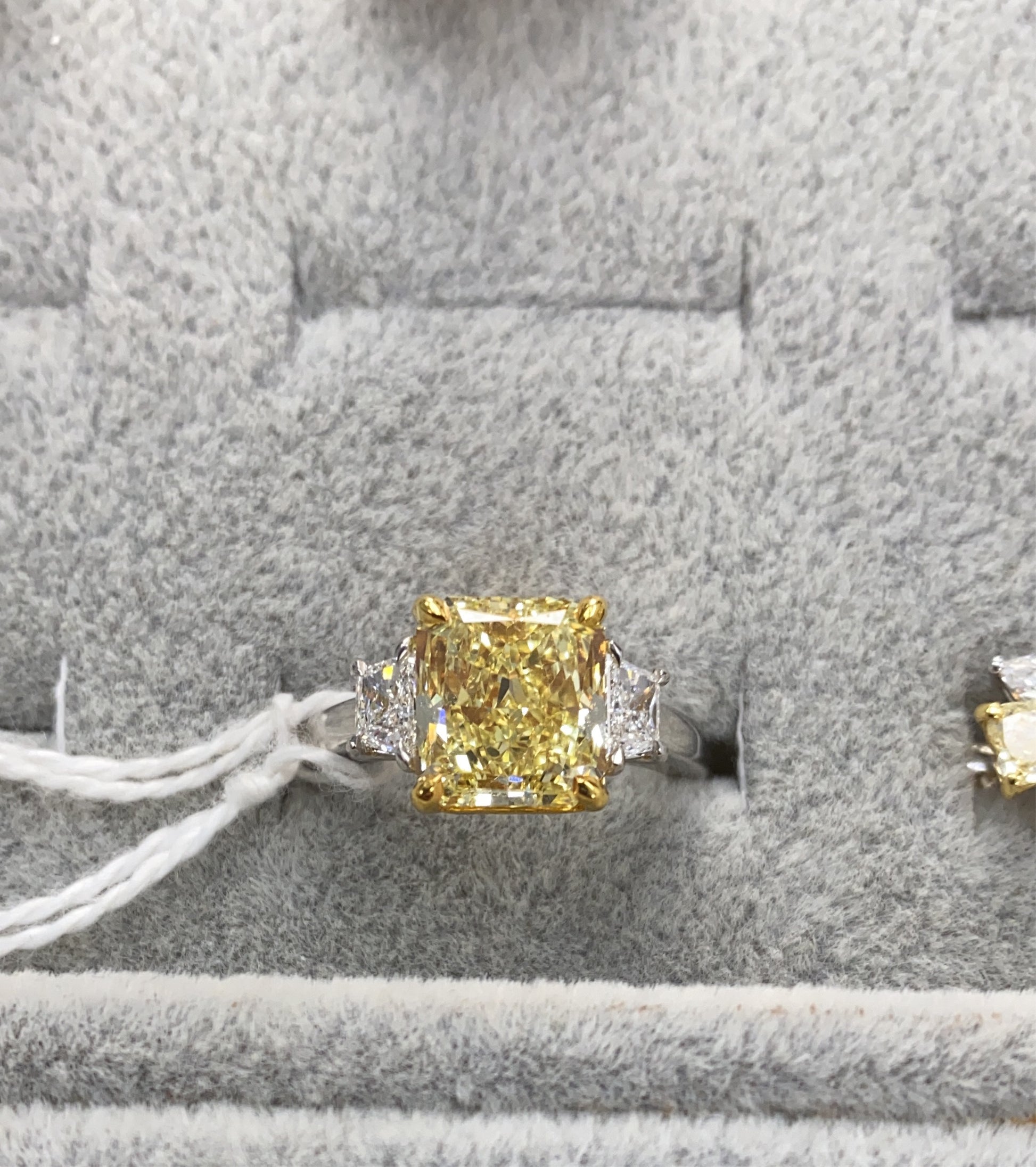 Fancy intense yellow diamond ring. Yellow diamond engagement ring. Yellow diamond jewelry. Yellow cushion cut diamond. Canary yellow diamond ring.